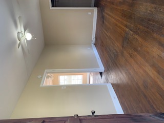 1105 Bentwood Road, Unit B Austin, TX 78722 - Photo 5 of 9 Spare room with dark wood finished floors and a ceiling fan