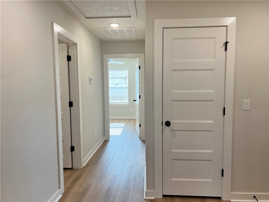 1715 Cuppett Circle Pea Ridge, AR 72751 - Photo 7 of 15 Hallway featuring wood-finish flooring and light-toned walls