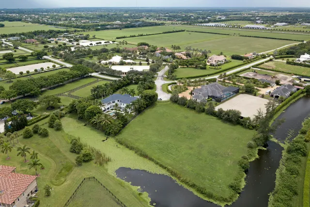an aerial view of a residential houses with outdoor space