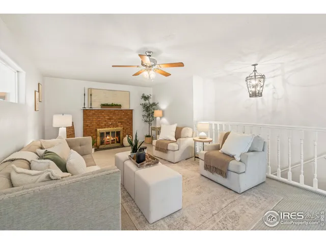 a living room with fireplace furniture and a chandelier