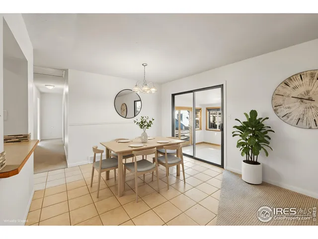 a living room with furniture and a potted plant on the wall