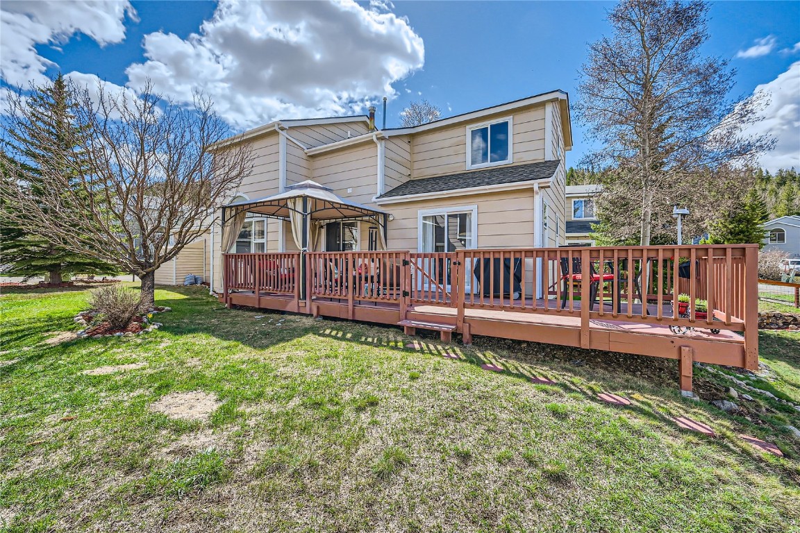852 Alpine Road Dillon, CO 80435 - Photo 27 of 29 a view of a house with a yard and a wooden deck