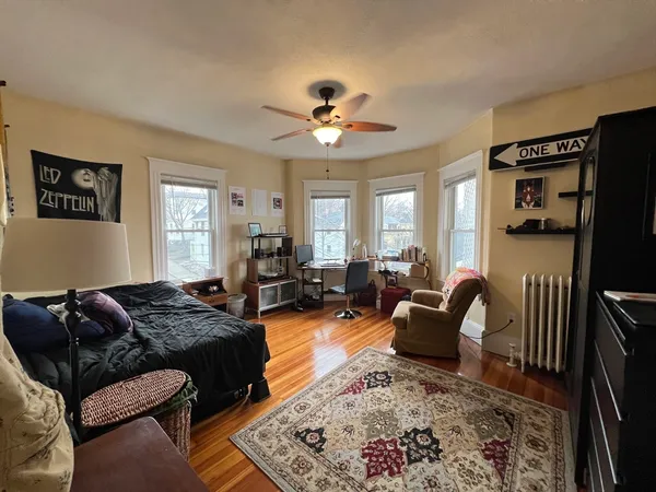 a living room with furniture ceiling fan and a rug