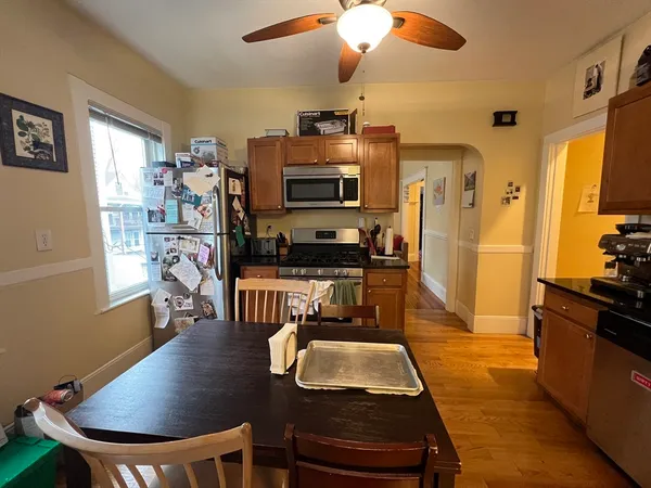 a living room with a table chairs and a dining table