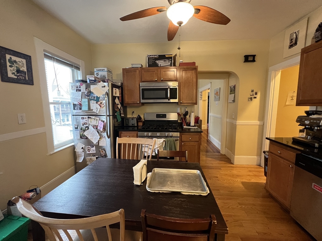 121 Liberty Road, Unit 3 Somerville, MA 02144 - Photo 12 of 24 a living room with a table chairs and a dining table