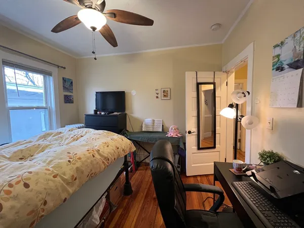 a bedroom with a bed and a chandelier