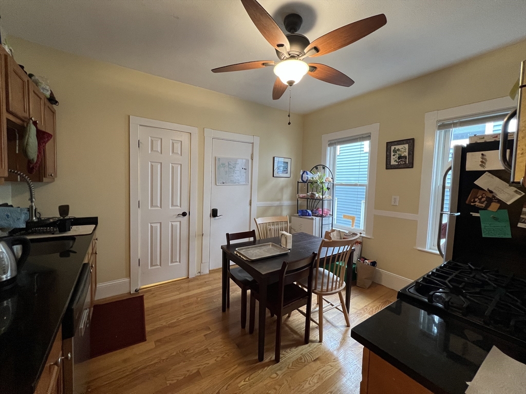 121 Liberty Road, Unit 3 Somerville, MA 02144 - Photo 14 of 24 a view of a dining room with furniture and wooden floor