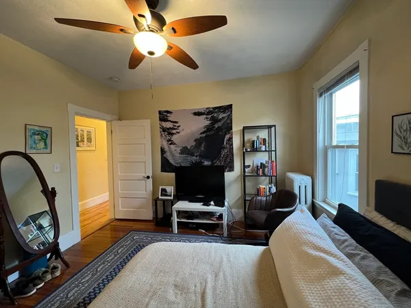a bedroom with furniture and a flat screen tv