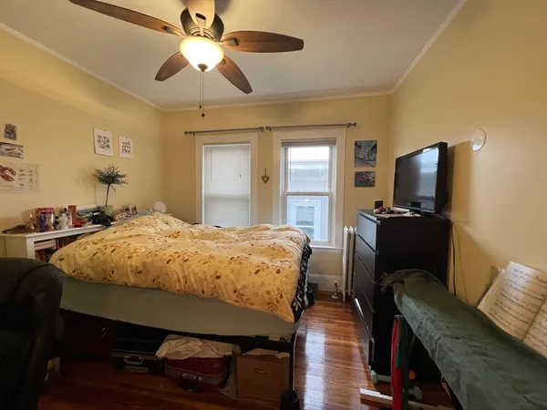 a bed room with a bed and a television