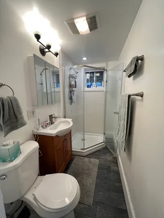 a bathroom with a sink toilet and shower