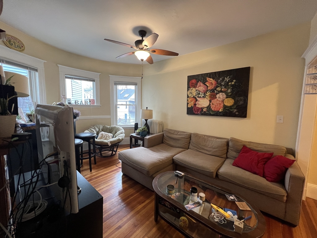 121 Liberty Road, Unit 3 Somerville, MA 02144 - Photo 3 of 24 a living room with furniture a ceiling fan and a window
