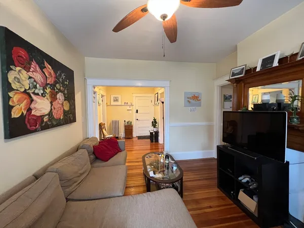 a bedroom with furniture and a flat screen tv