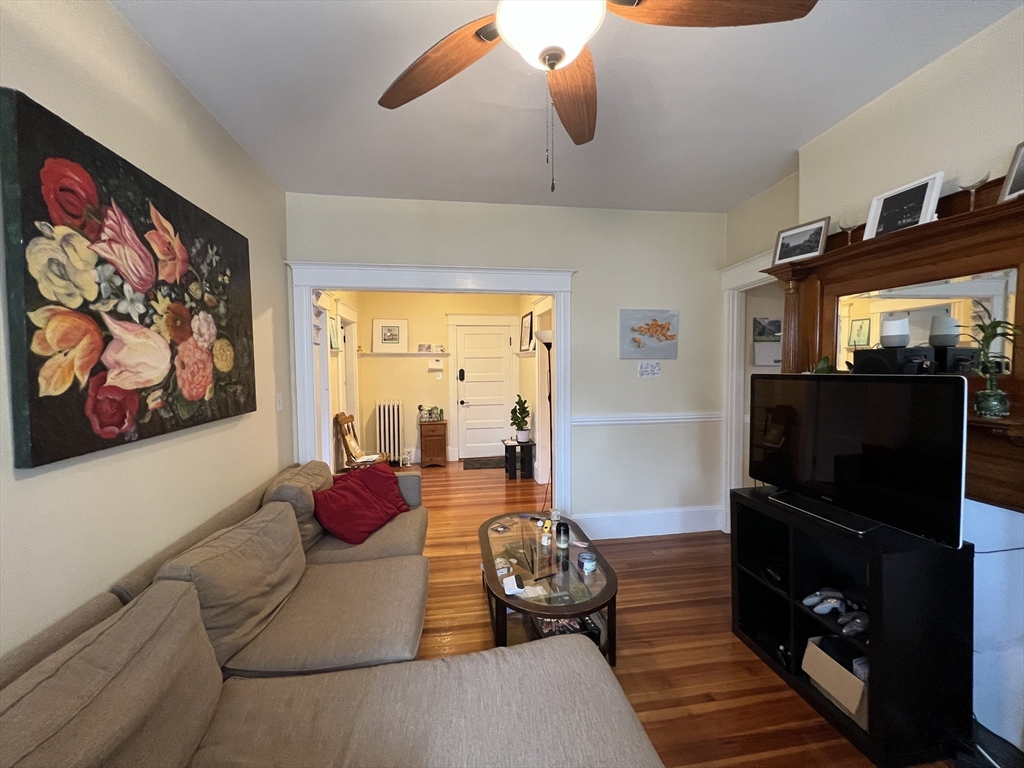 121 Liberty Road, Unit 3 Somerville, MA 02144 - Photo 4 of 24 a bedroom with furniture and a flat screen tv