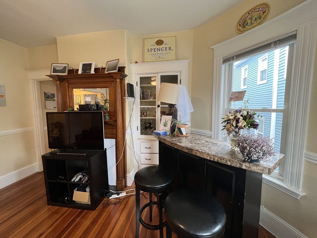 121 Liberty Road, Unit 3 Somerville, MA 02144 - Photo 5 of 24 a kitchen with a table and chairs in it