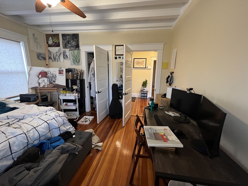 121 Liberty Road, Unit 3 Somerville, MA 02144 - Photo 8 of 24 a bedroom with a bed and wooden floor