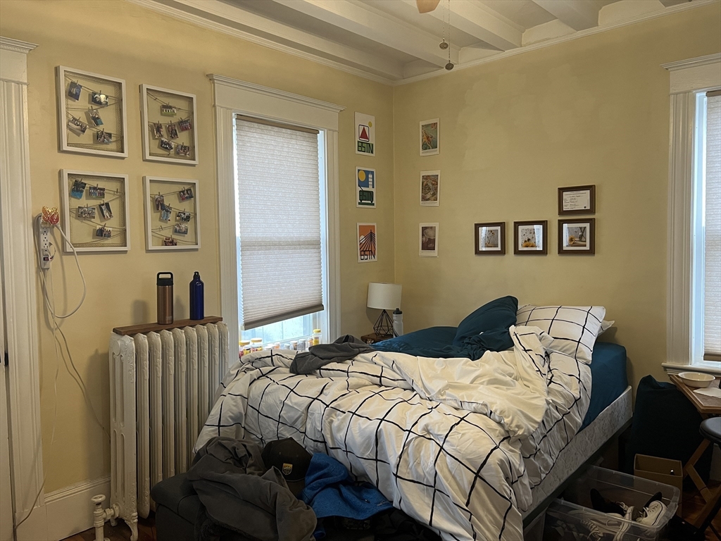 121 Liberty Road, Unit 3 Somerville, MA 02144 - Photo 9 of 24 a bedroom with a bed and wall painting