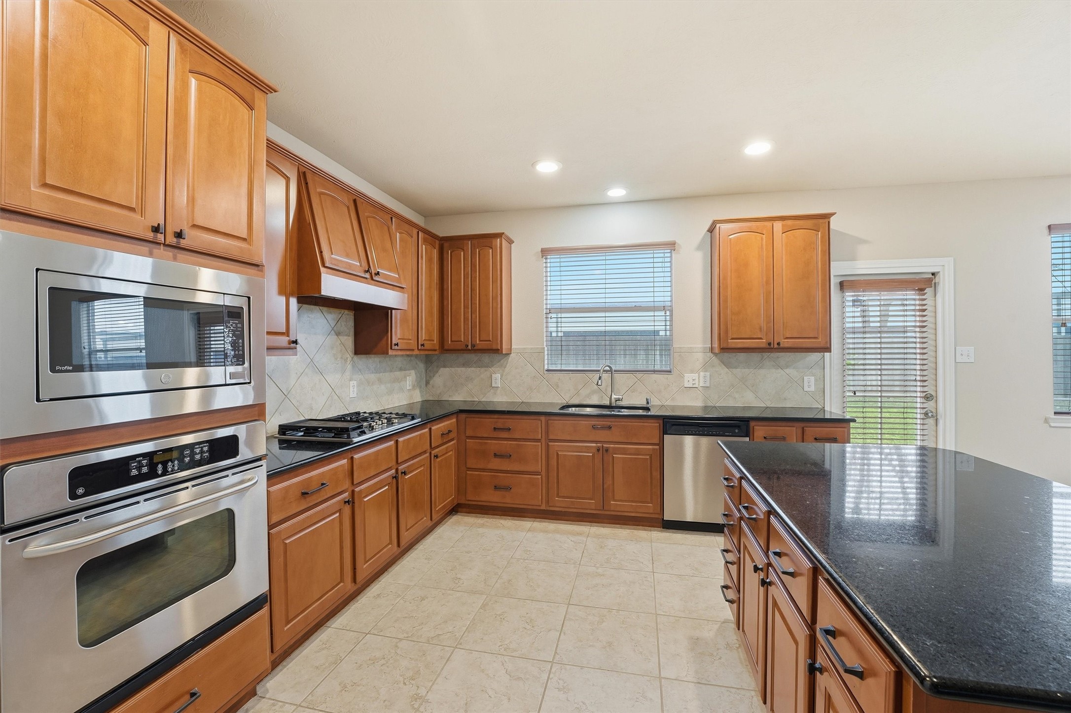 17415 Memorial Mills Drive Spring, TX 77379 - Photo 19 of 39 Stainless steel appliances, a gas cooktop, and ample counter space complete this functional kitchen design.