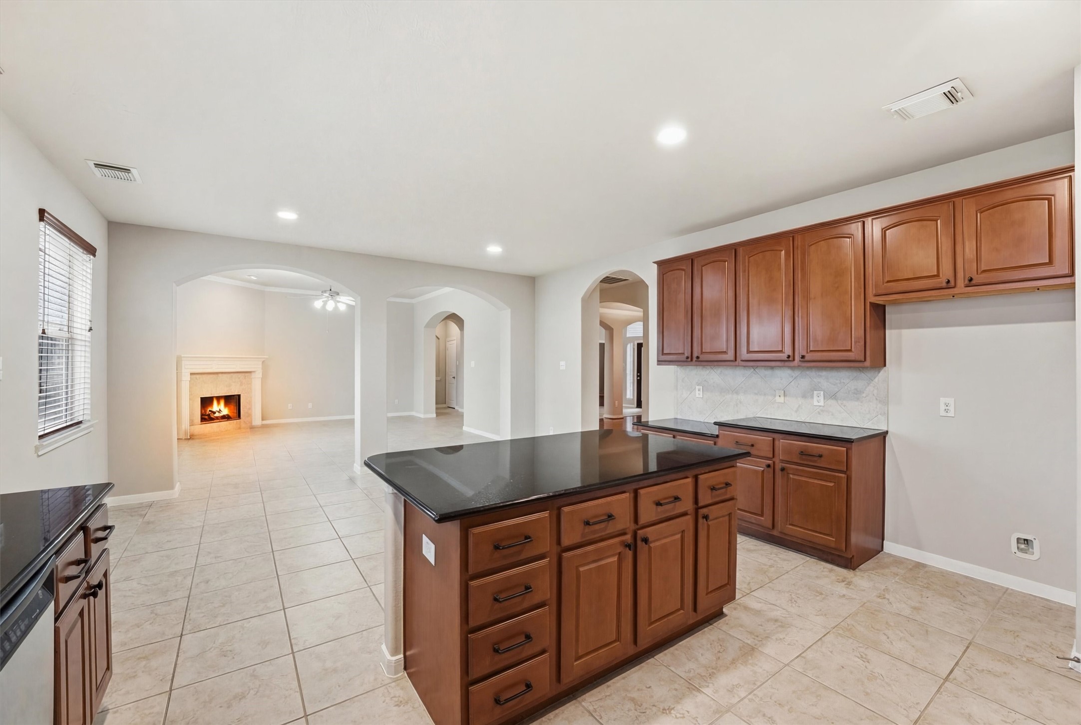 17415 Memorial Mills Drive Spring, TX 77379 - Photo 20 of 39 View from the kitchen highlights the open layout with arched openings to the living and dining areas.