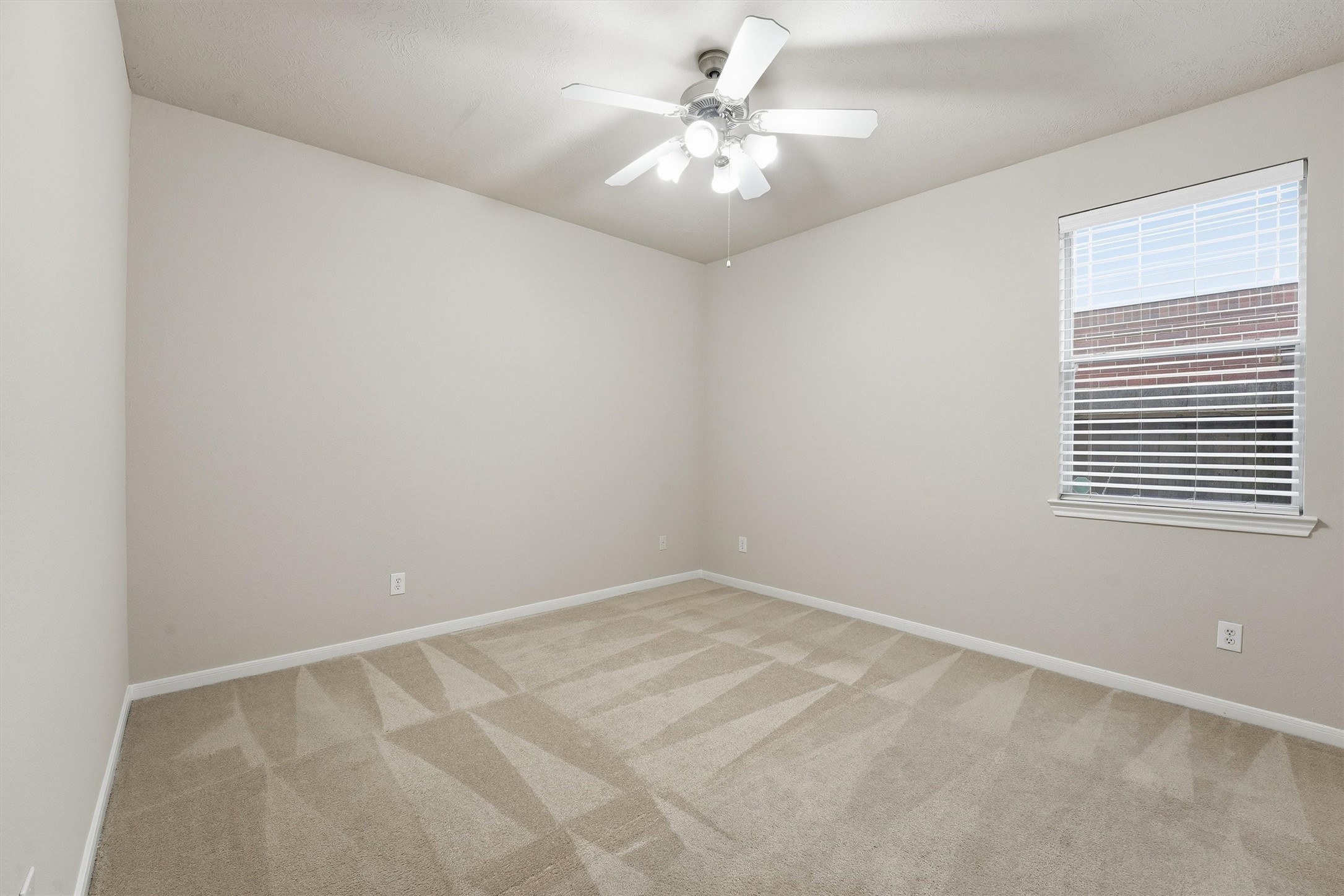 17415 Memorial Mills Drive Spring, TX 77379 - Photo 24 of 39 an empty room with windows and fan