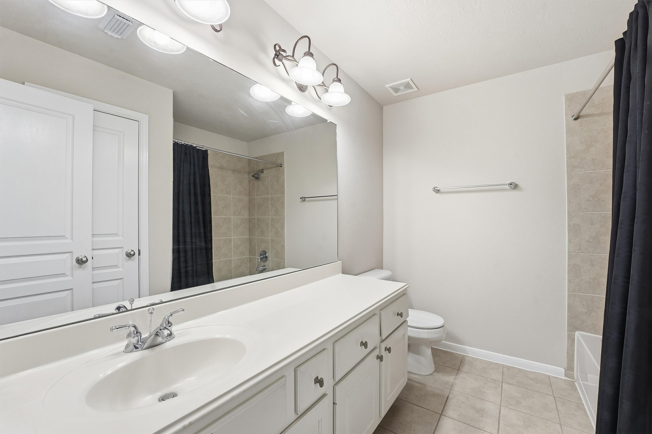 17415 Memorial Mills Drive Spring, TX 77379 - Photo 32 of 39 a bathroom with a sink a toilet and a mirror