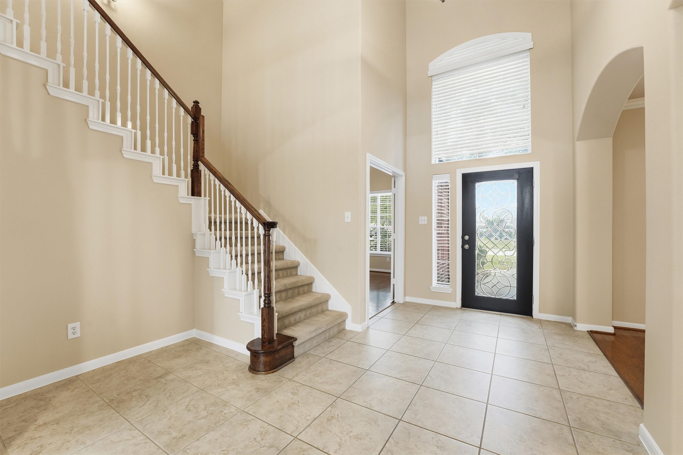 17415 Memorial Mills Drive Spring, TX 77379 - Photo 10 of 39 The welcoming foyer features soaring ceilings, tile flooring, and a sweeping staircase with white balusters and wood handrail.