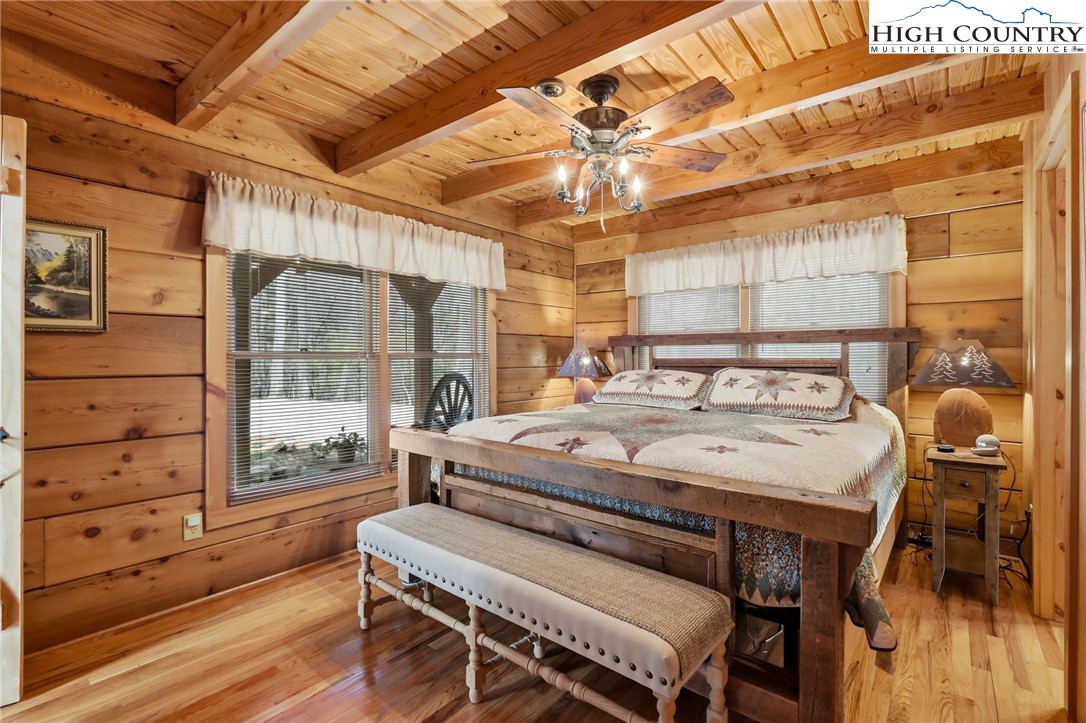 130 Hawkbill Road Ferguson, NC 28624 - Photo 12 of 50 a bedroom with a bed and wooden floor