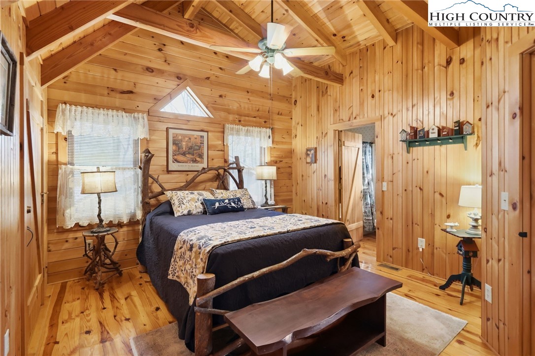 130 Hawkbill Road Ferguson, NC 28624 - Photo 18 of 50 a bedroom with a bed and a chandelier