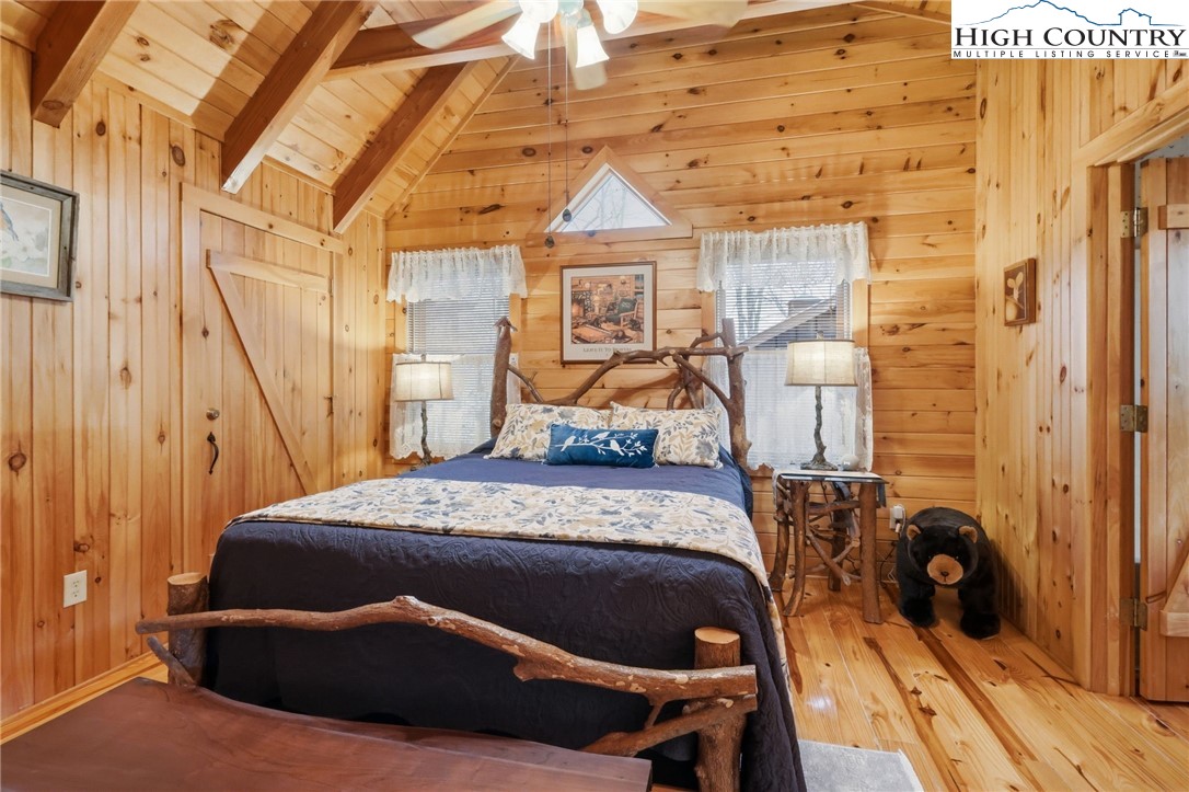 130 Hawkbill Road Ferguson, NC 28624 - Photo 19 of 50 a bedroom with a bed and wooden floor