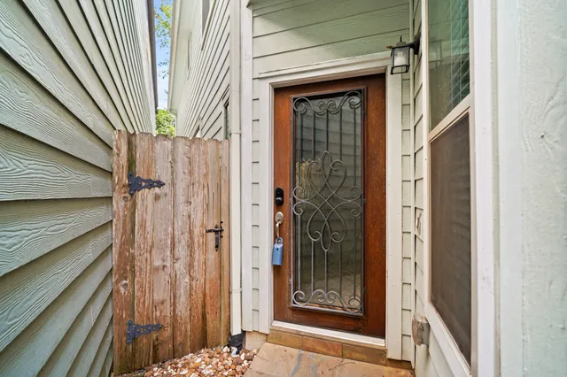 a view of a wooden door of the house