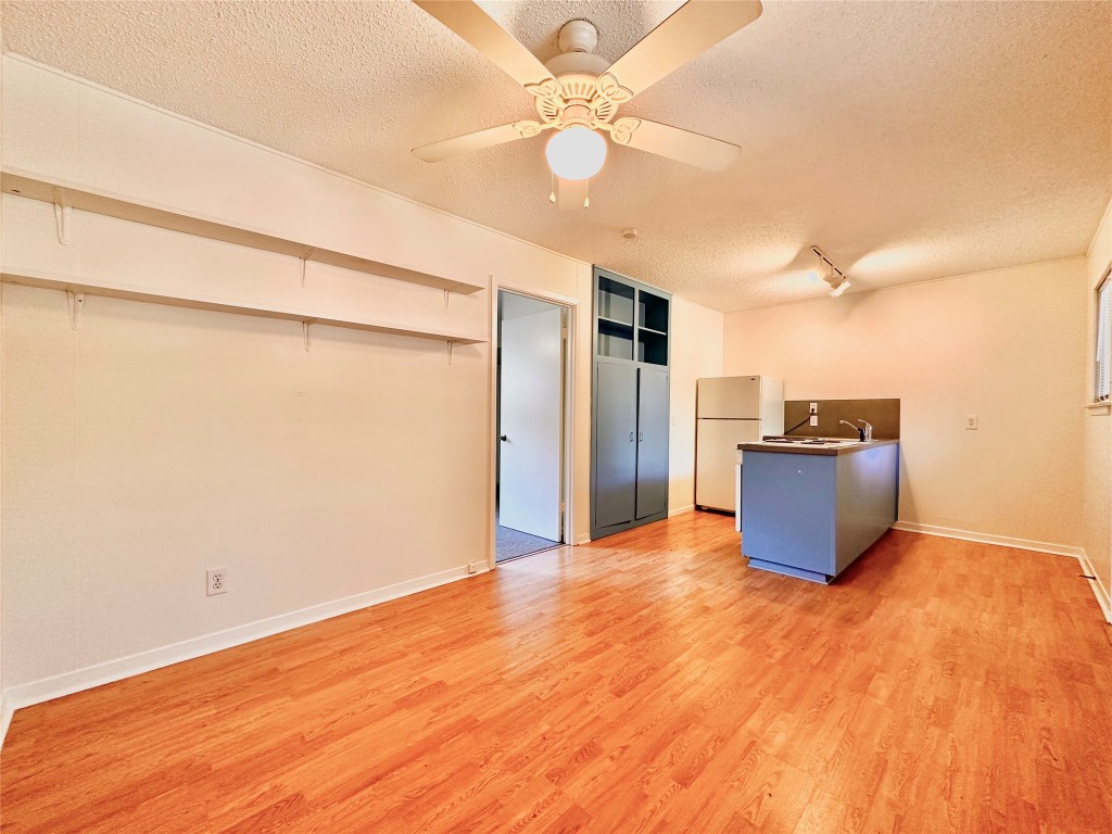 2711 Hemphill Park, Unit E Austin, TX 78705 - Photo 1 of 1 a view of a kitchen with a dishwasher cabinets and wooden floor