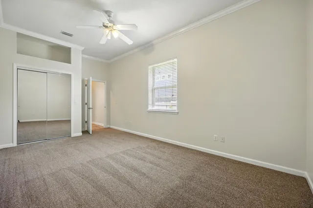 a view of an empty room with a fireplace and a window