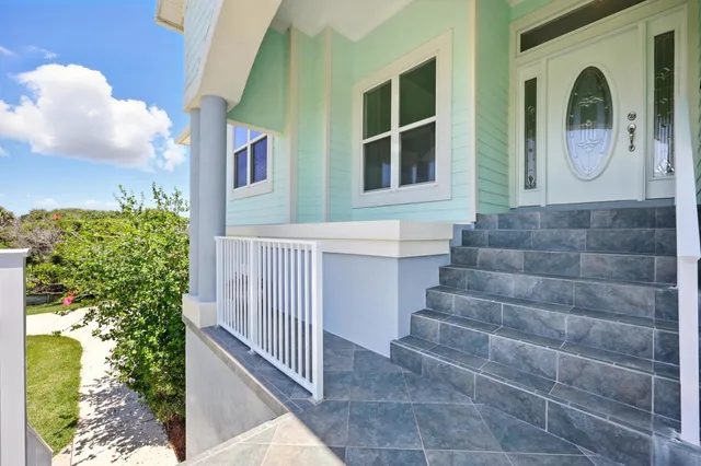 a view of a kitchen with kitchen island granite countertop wooden cabinets and stainless steel appliances