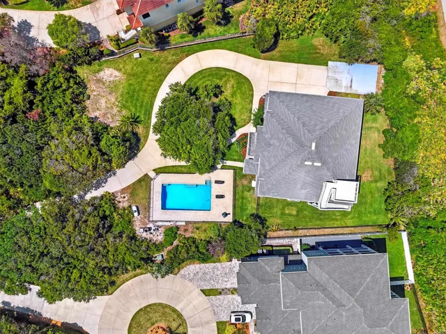 an aerial view of a house with a swimming pool outdoor seating and yard