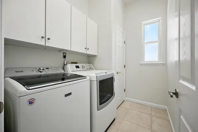 an aerial view of residential houses with outdoor space and parking
