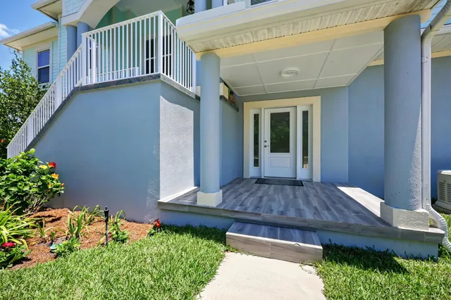 a kitchen with a refrigerator a stove top oven and white cabinets