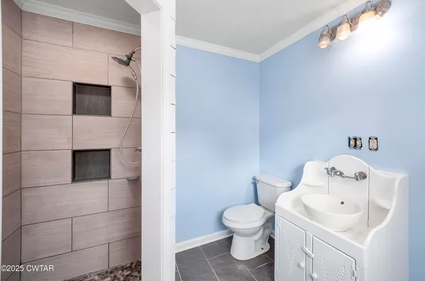 a white toilet sitting next to a bathroom sink