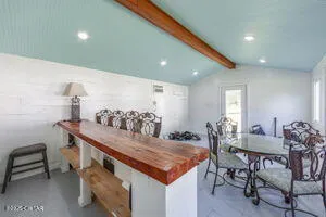 a living room with a table and chairs