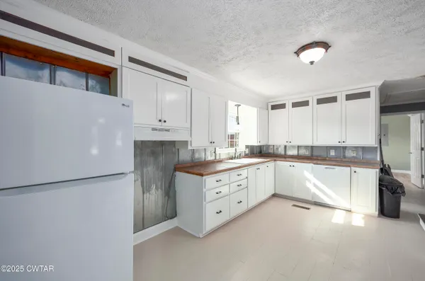 a large kitchen with cabinets and stainless steel appliances