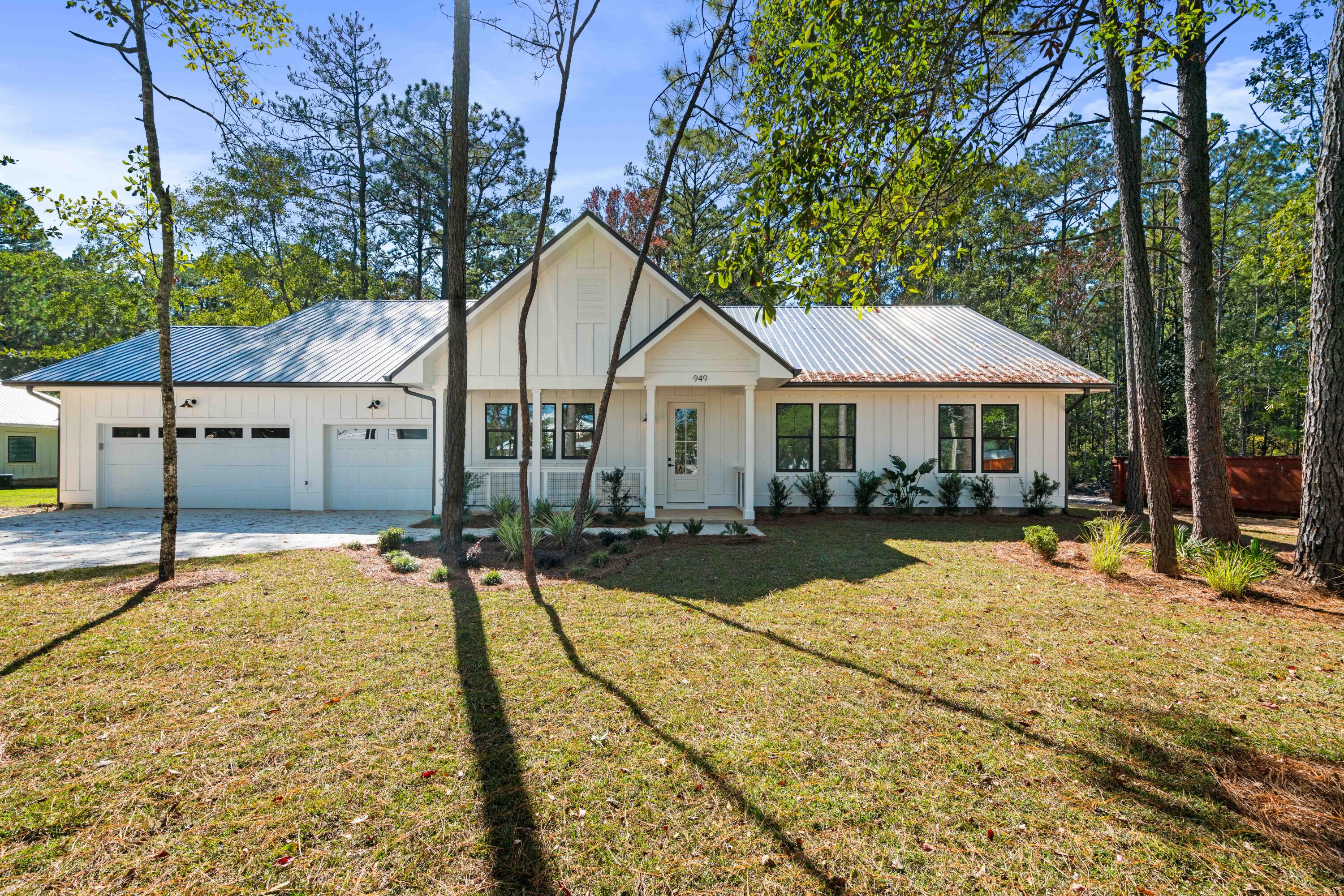 949 Bay Grove Road Freeport, FL 32439 - Photo 1 of 44 a house with trees in the background