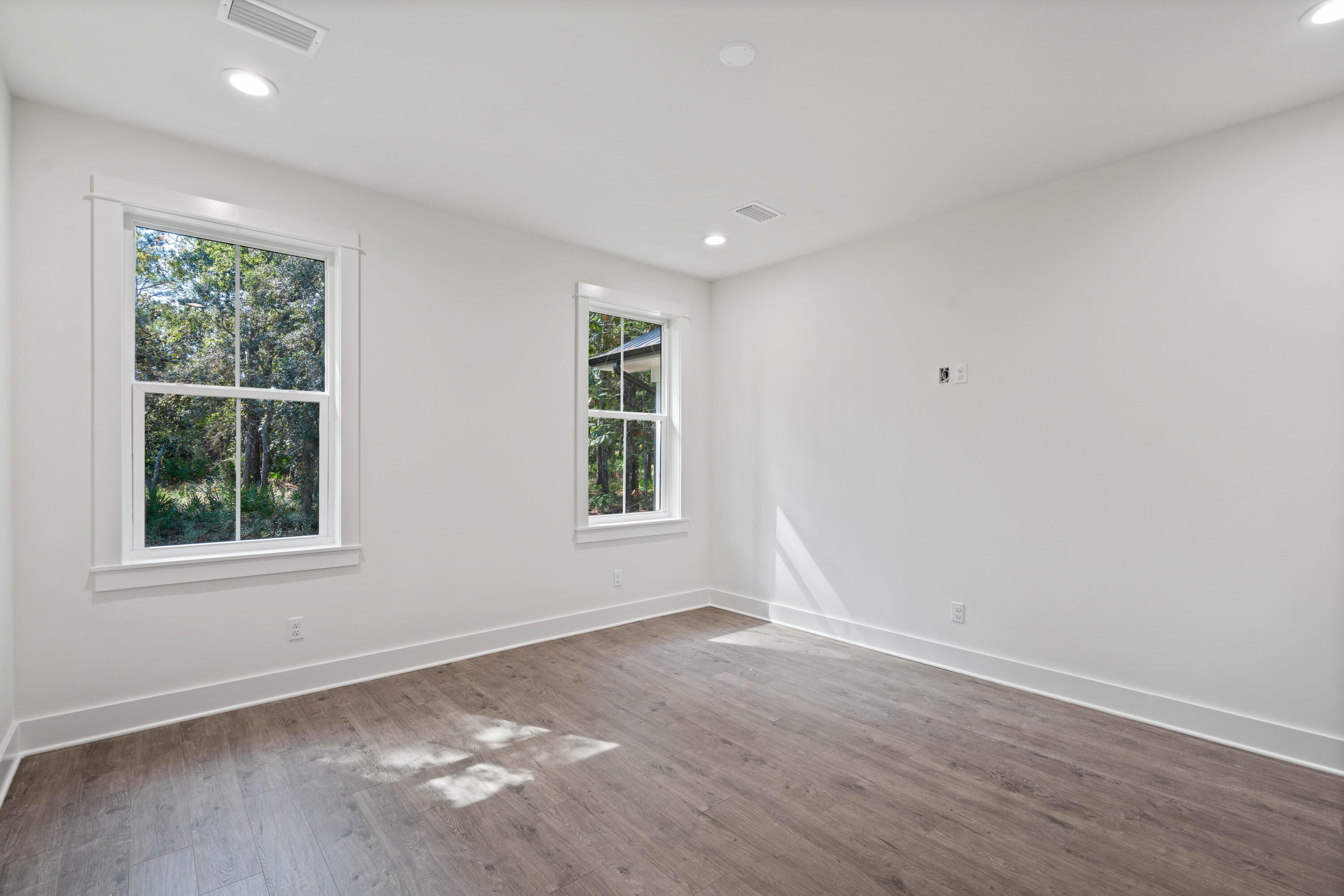 949 Bay Grove Road Freeport, FL 32439 - Photo 17 of 44 an empty room with wooden floor and windows
