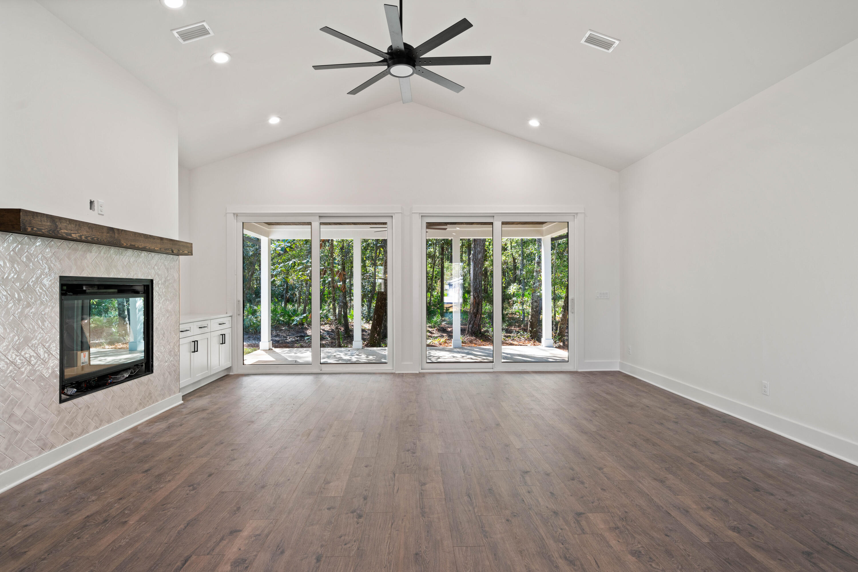 949 Bay Grove Road Freeport, FL 32439 - Photo 4 of 44 a view of an empty room with a fireplace and a window