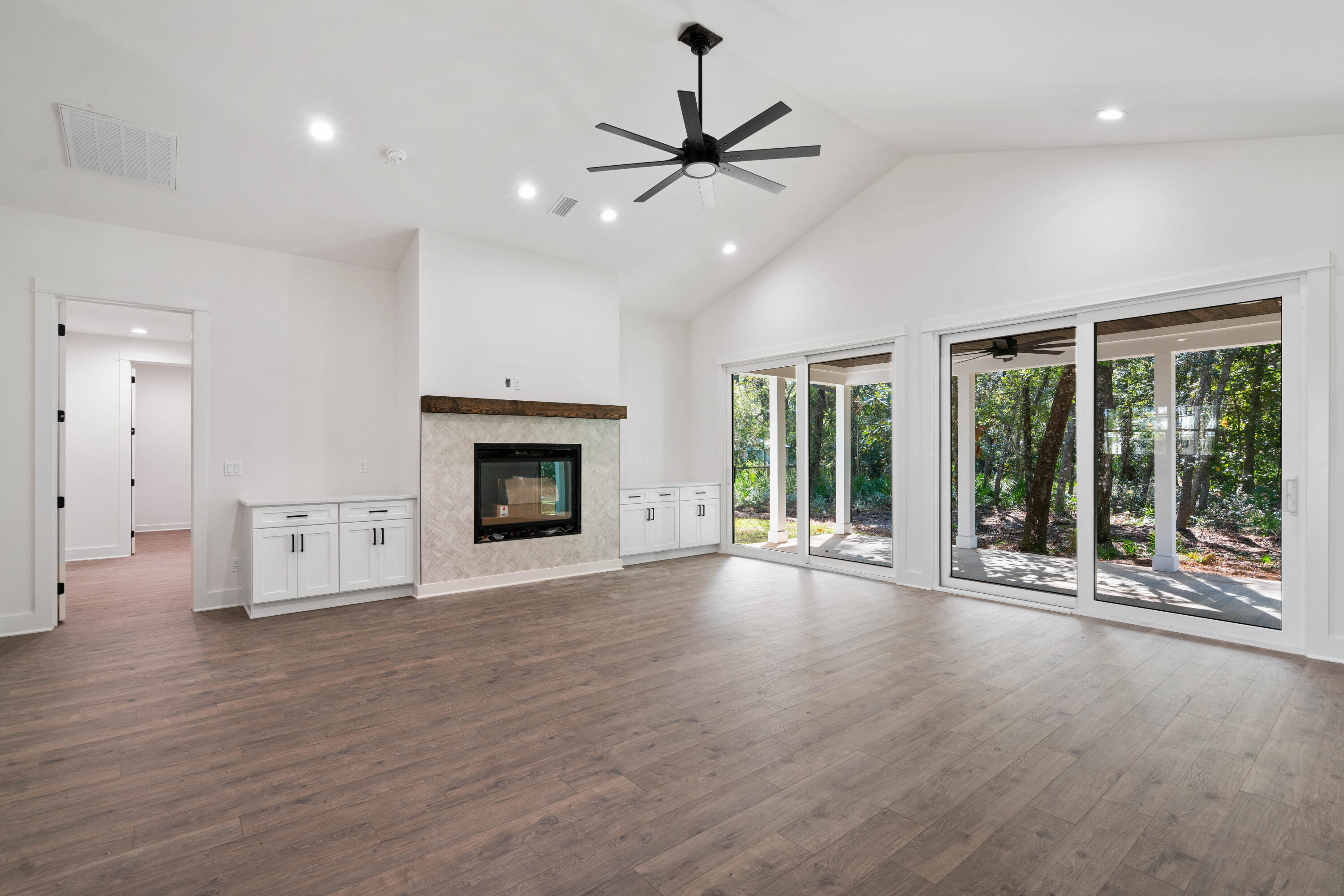 949 Bay Grove Road Freeport, FL 32439 - Photo 5 of 44 a view of an empty room with wooden floor and a fireplace