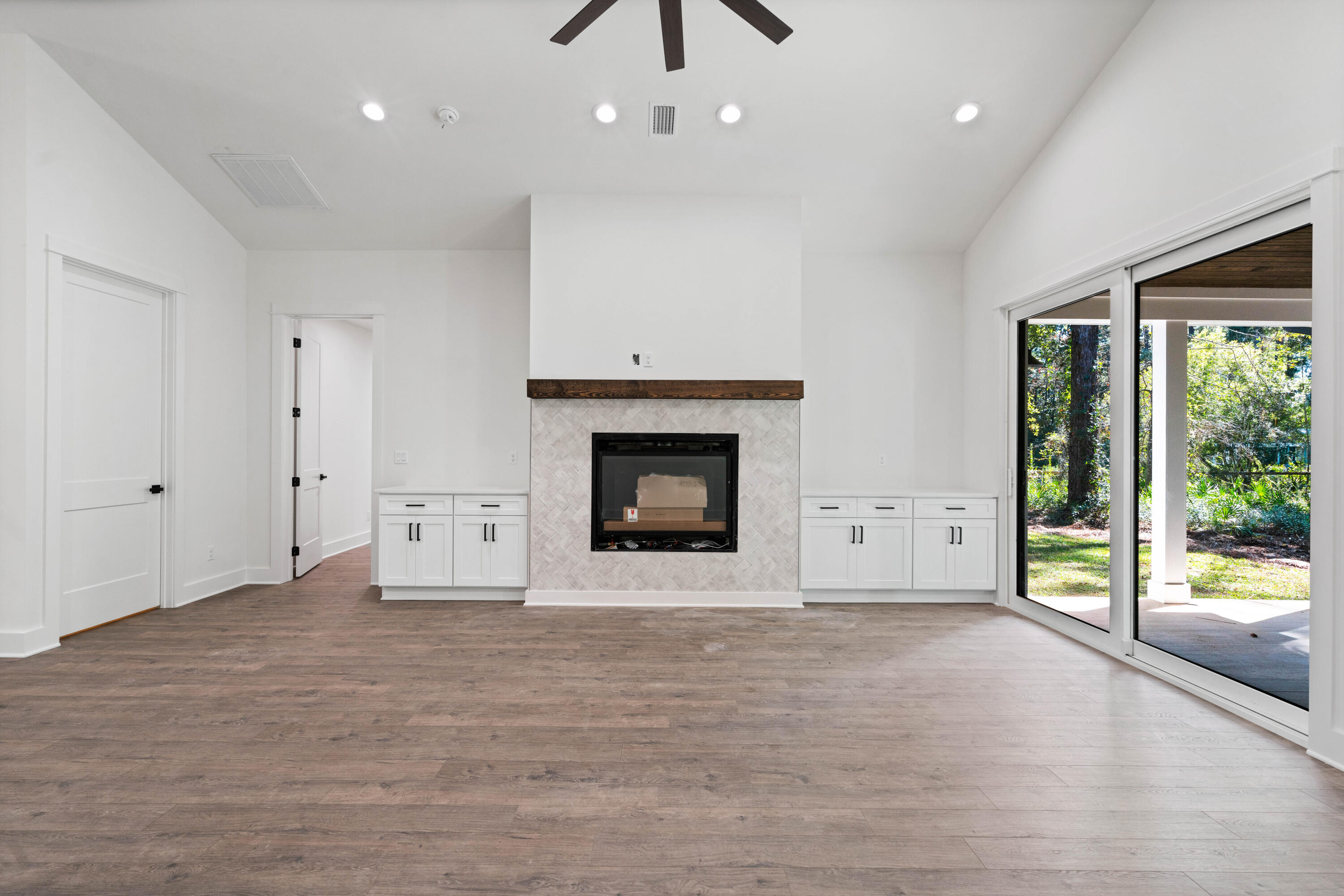 949 Bay Grove Road Freeport, FL 32439 - Photo 6 of 44 a view of an empty room with a fireplace and a window