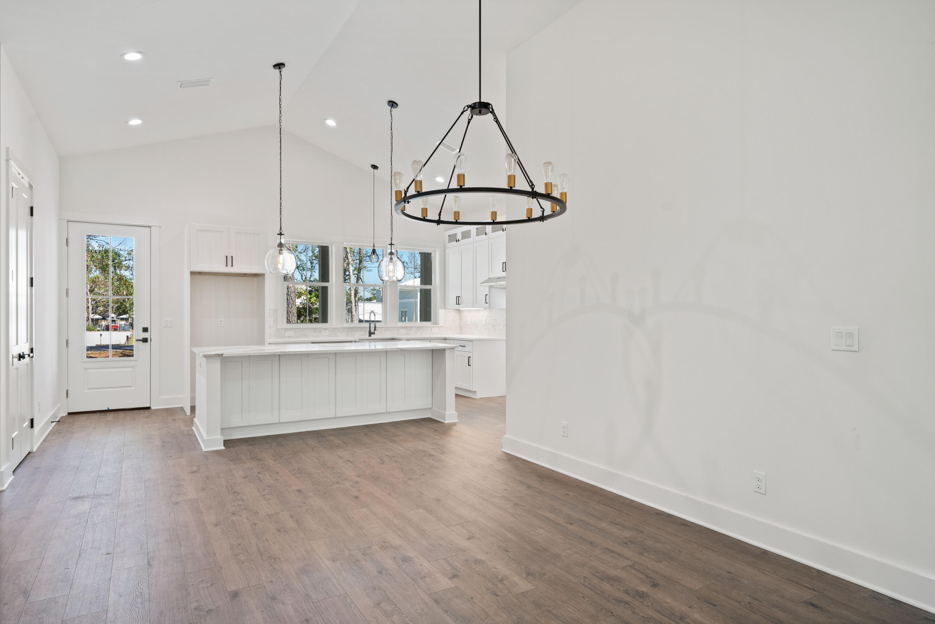 949 Bay Grove Road Freeport, FL 32439 - Photo 8 of 44 a kitchen with kitchen island a counter space and a wooden floor