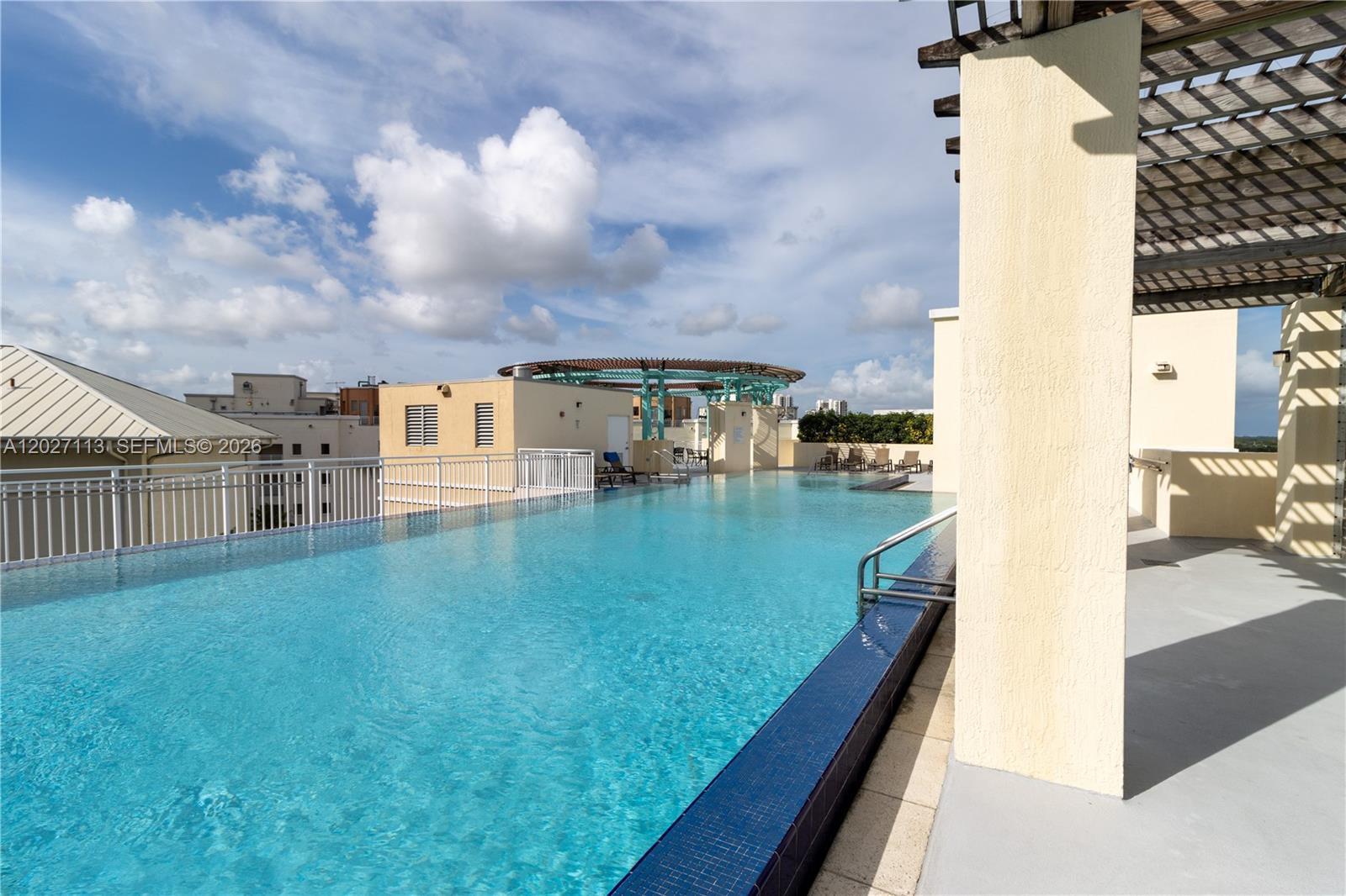 7275 Southwest 90th Way, Unit 213 Miami, FL 33156 - Photo 27 of 31 a view of swimming pool from a balcony
