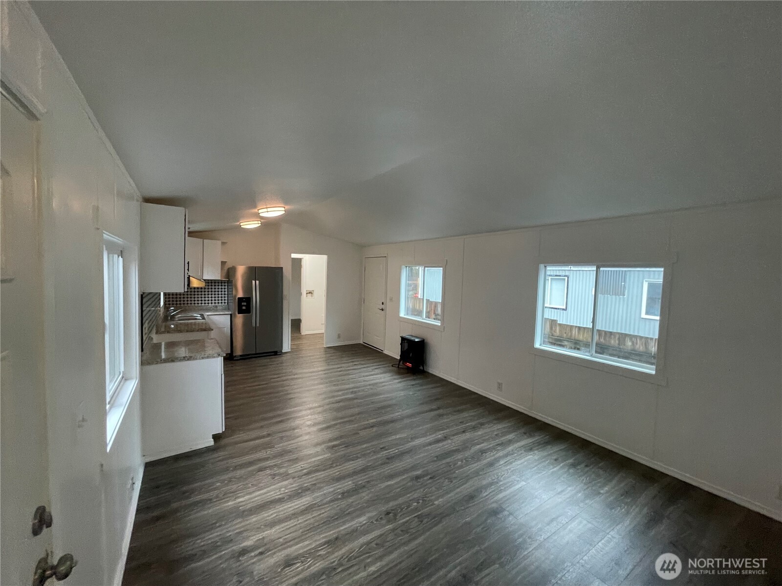 5705 Littlerock Road Southwest, Unit 16 Tumwater, WA 98512 - Photo 12 of 18 a view of a kitchen with a sink stove refrigerator and cabinets
