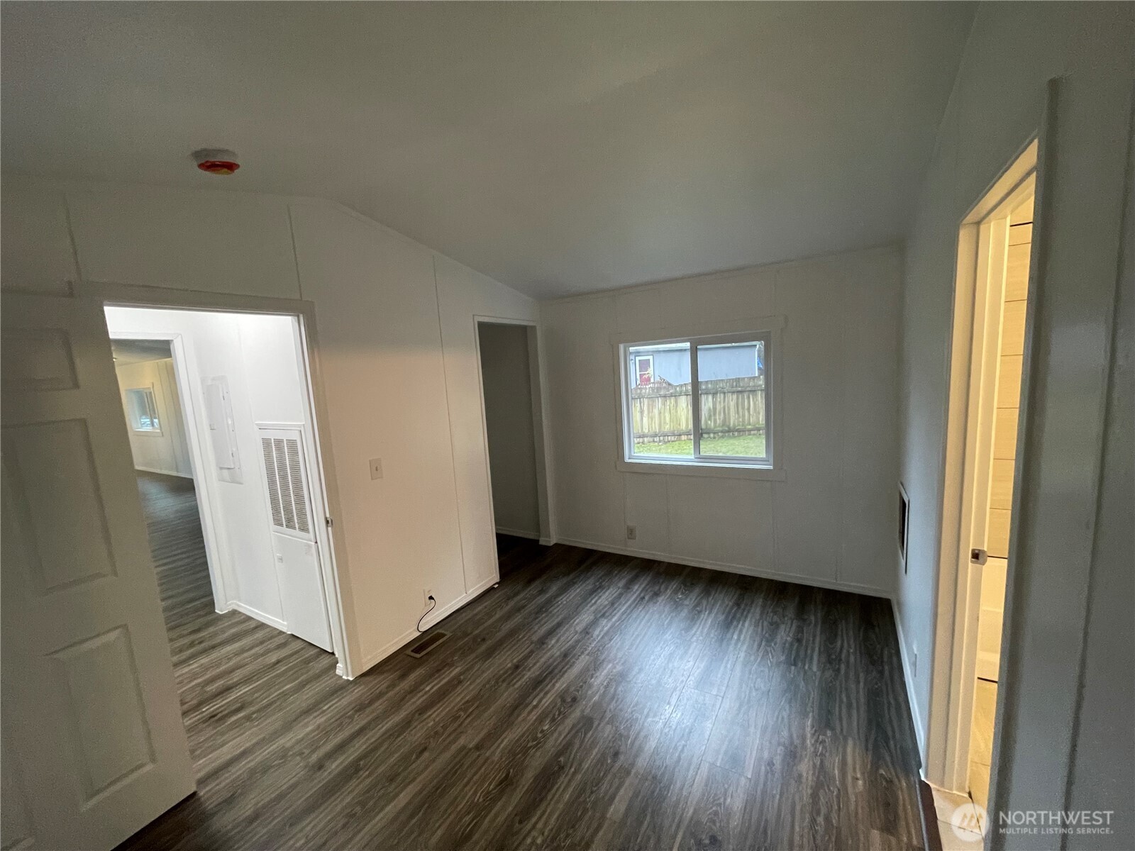 5705 Littlerock Road Southwest, Unit 16 Tumwater, WA 98512 - Photo 18 of 18 an empty room with wooden floor and windows