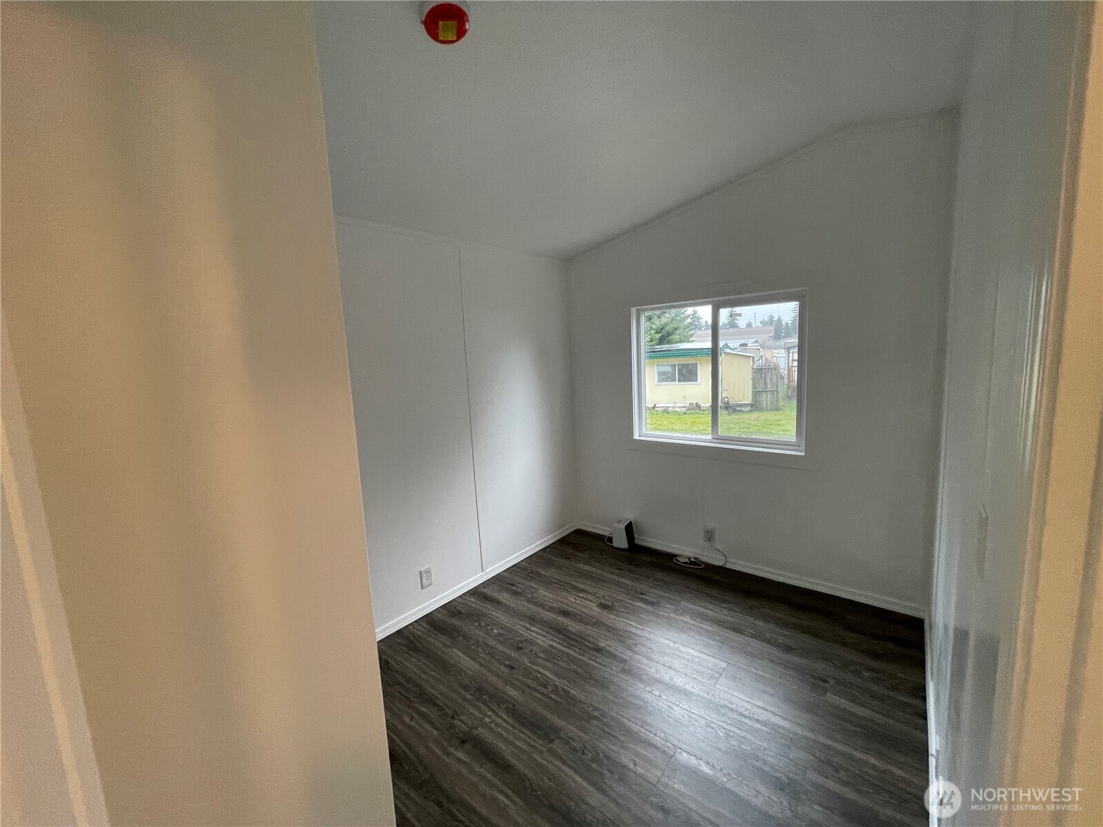 5705 Littlerock Road Southwest, Unit 16 Tumwater, WA 98512 - Photo 8 of 18 an empty room with wooden floor and windows
