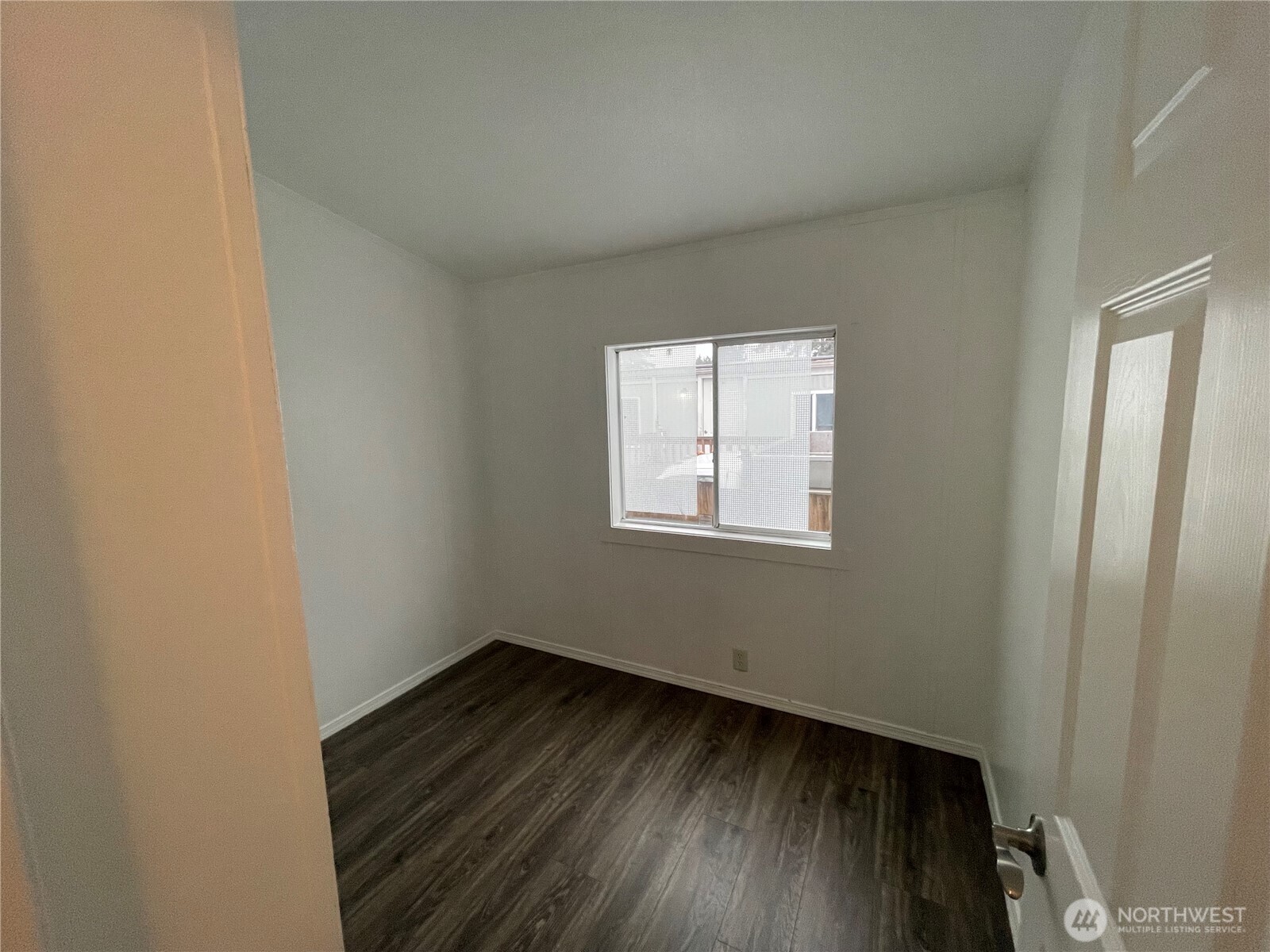 5705 Littlerock Road Southwest, Unit 16 Tumwater, WA 98512 - Photo 9 of 18 an empty room with wooden floor and windows