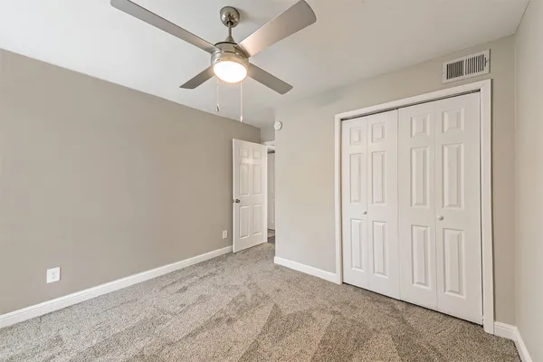 a view of a kitchen with wooden floor a sink a refrigerator and window